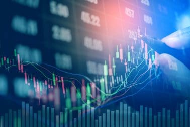 Businessman writing the trading graph of stock market on digital stock market financial exchange and Trading graph