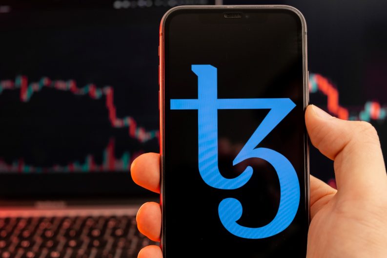 tezos xtz logo on mobile phone