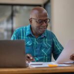 UK expat reviewing financial documents while living overseas