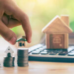 Person reviewing investment documents on tablet with coffee