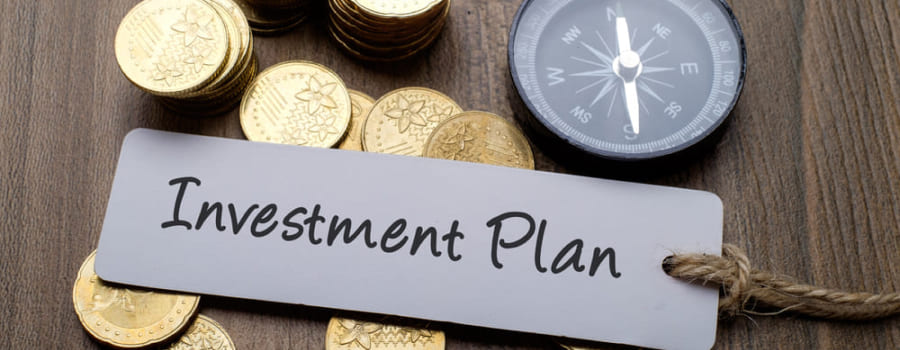 Investment planning concept with compass and coins