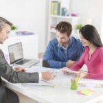 Financial advisor helping couple with ISA transfer paperwork