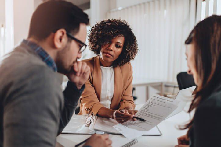 Financial advisor reviewing transfer documents with clients