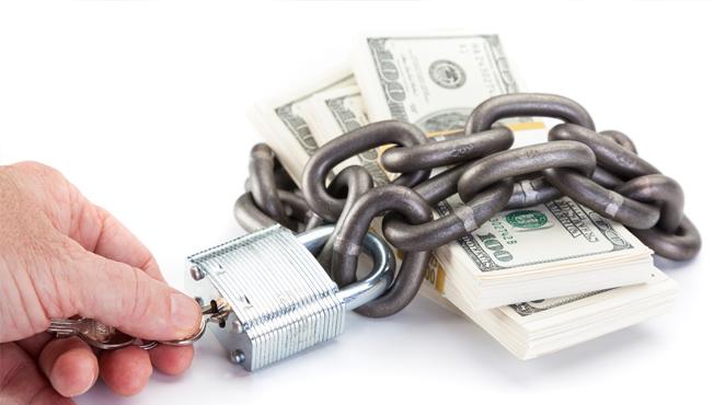 Secured money with padlock and keys