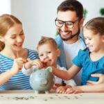 Family learning about saving money with piggy bank