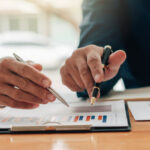 Business professionals reviewing financial documents and charts