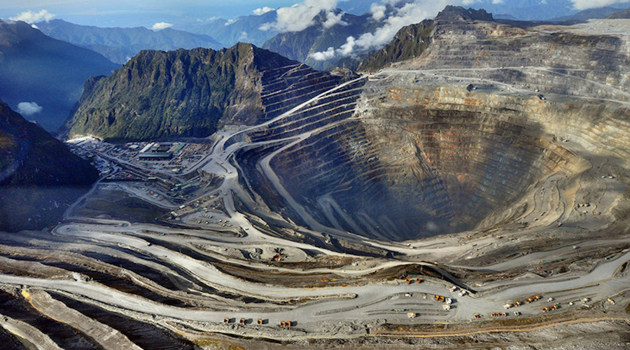 Aerial view of Freeport-McMoRan's Grasberg mining complex in Indonesia showing the massive open-pit mine and surrounding infrastructure