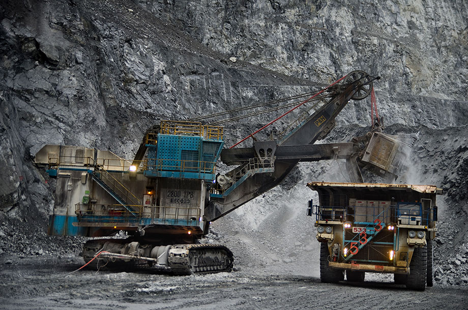 Massive mining equipment at work in the Grasberg pit, showing the scale of operations and heavy machinery used in copper extraction