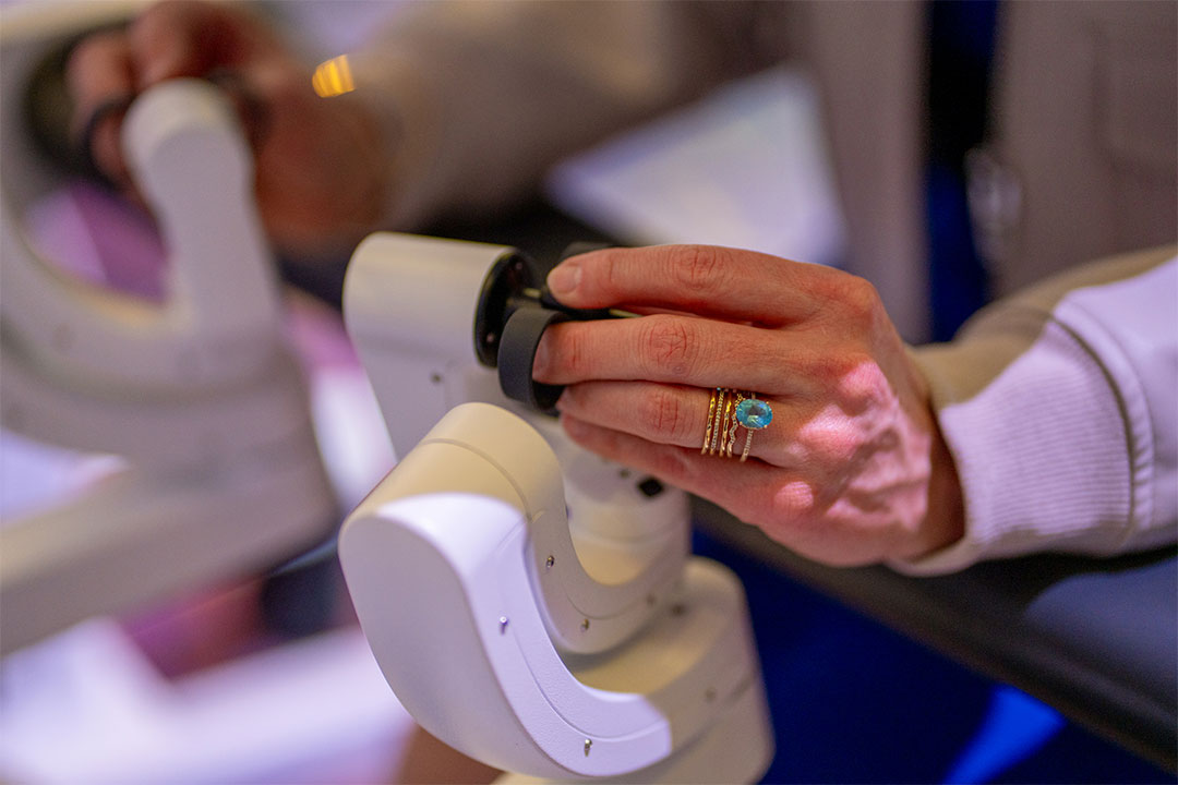 Close-up of surgeon hands operating da Vinci master controls with precision instruments