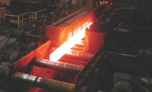 Steel mill production with glowing hot steel billet