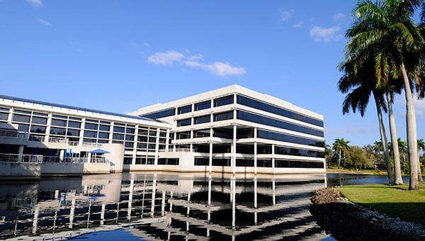 NextEra Energy corporate headquarters building with modern architecture reflected in water