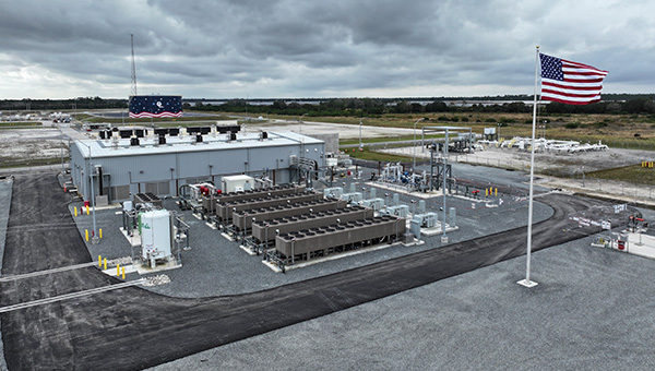 NextEra Energy industrial facility with battery storage infrastructure and American flag