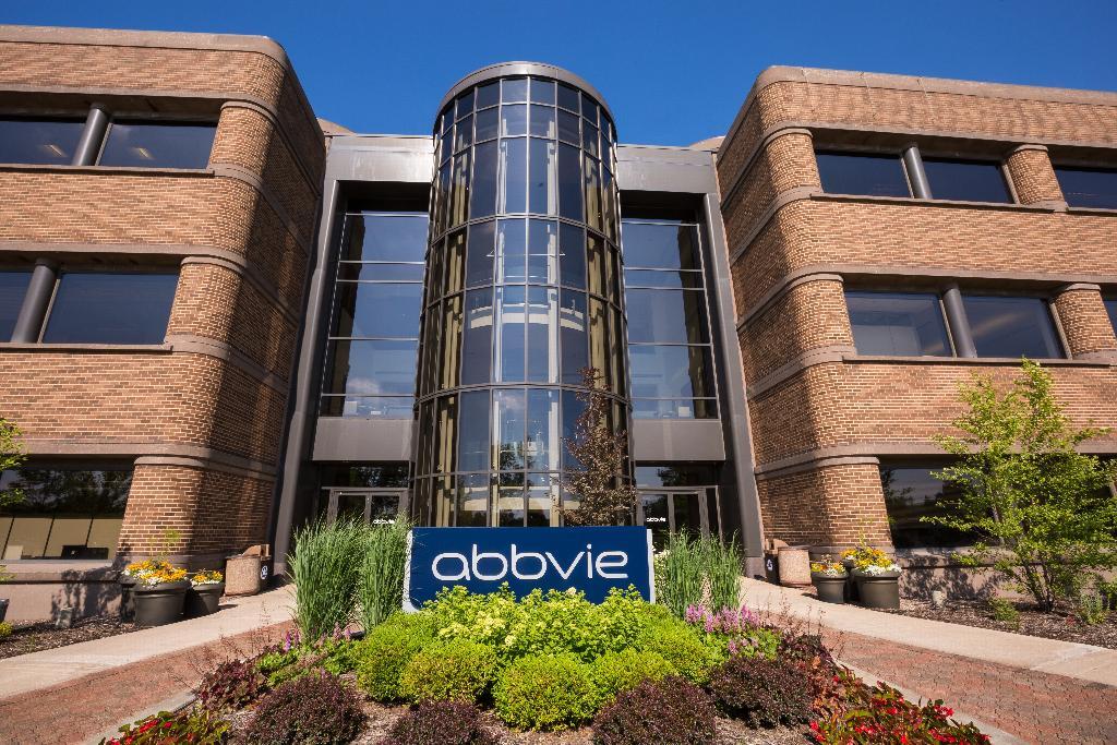 AbbVie corporate headquarters in North Chicago showing the modern pharmaceutical campus with curved glass atrium entrance and company signage