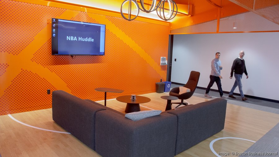 DraftKings office basketball-themed lounge area with NBA Huddle display and court-style flooring