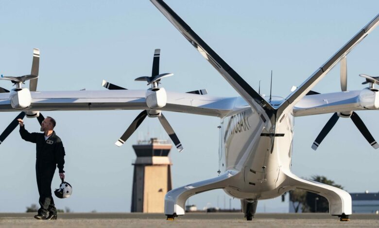Archer Aviation engineer examining prototype aircraft on airfield tarmac
