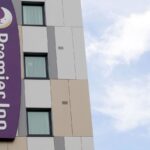 Premier Inn hotel exterior with adjoining restaurant unit, representing Whitbread's UK hospitality estate.