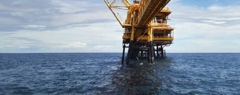 Offshore oil and gas production platform in the ocean, representing offshore E&P operations