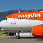 An orange-and-white easyJet Airbus aircraft on the tarmac, illustrating coverage of the Apollo takeover deadline extension.