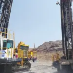 Two Capital Drilling rigs operating at a mining site, illustrating Capital Limited's drilling services business.