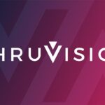 Thruvision company logo on a dark blue-to-pink gradient background with a large stylised chevron/arrow motif