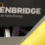 Close-up of an Enbridge company sign with logo and tagline 'Life Takes Energy'.