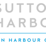 Panoramic view of Sutton Harbour marina with moored boats and quayside buildings