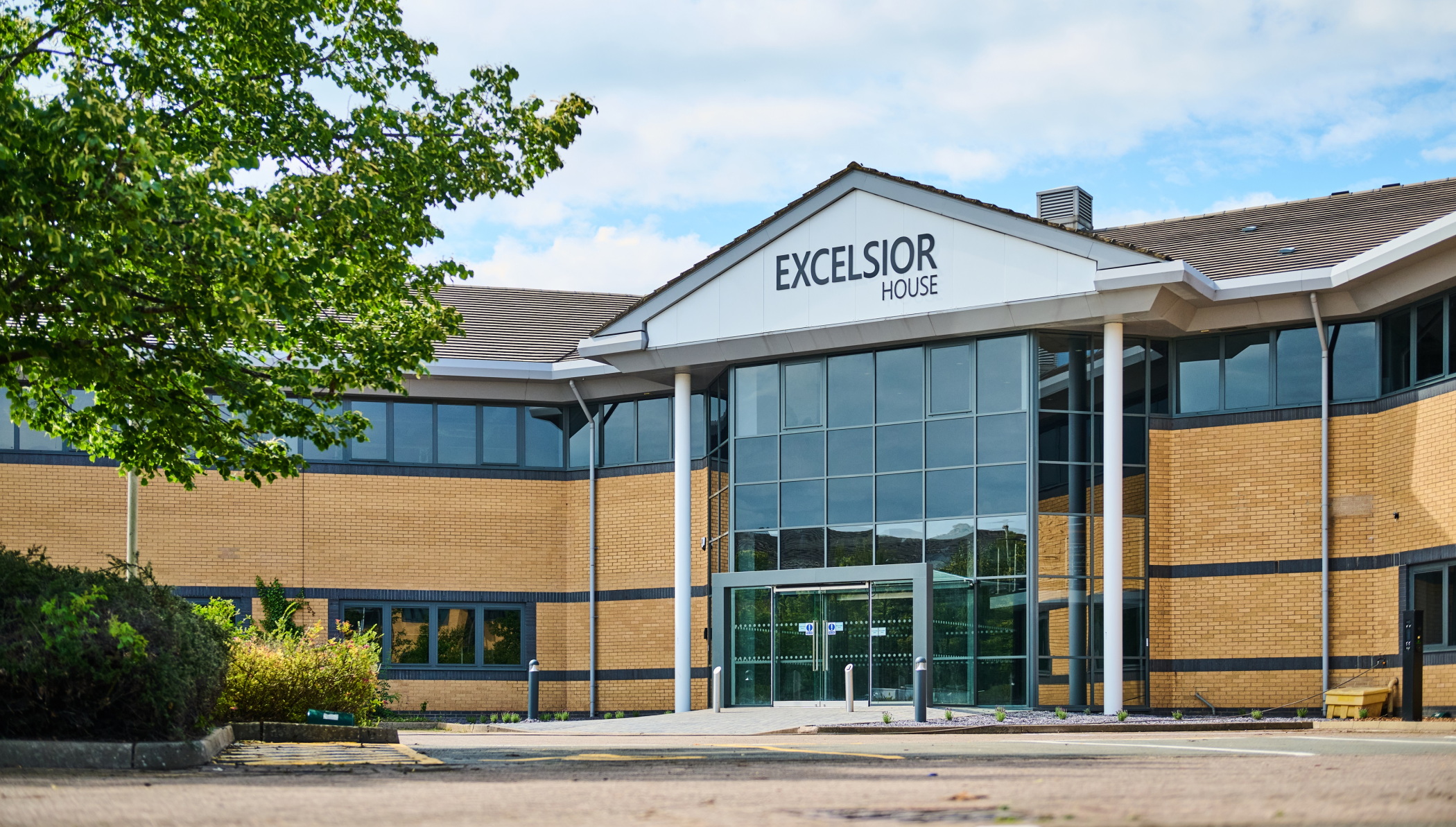 Excelsior House office building exterior with brick facade, glass entrance, and 'Excelsior House' signage