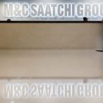 Reception area of M&C Saatchi Group's office with an illuminated wall sign reading 'M&C Saatchi Group' above the front desk