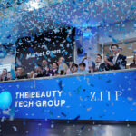 Executives and staff of The Beauty Tech Group celebrate with confetti under a 'Market Open' sign during their London Stock Exchange listing ceremony