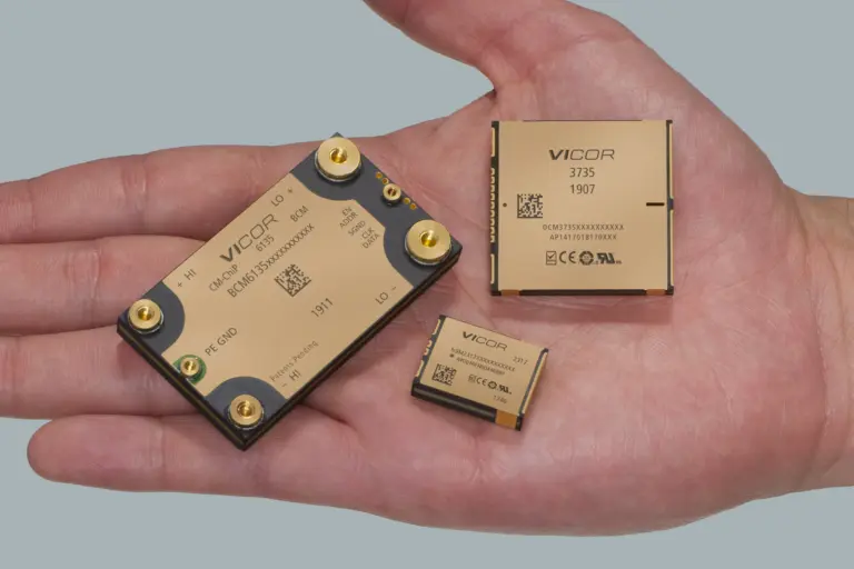Palm holding three gold Vicor power modules: BCM6135, DCM3735 and NBM2317