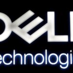 Illuminated Dell Technologies logo sign on a dark background