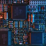 Close-up of an electronic circuit board with microchips, symbolising technology sector investment