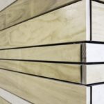 Close-up of light-coloured wood cladding panels with visible grain and cut edges