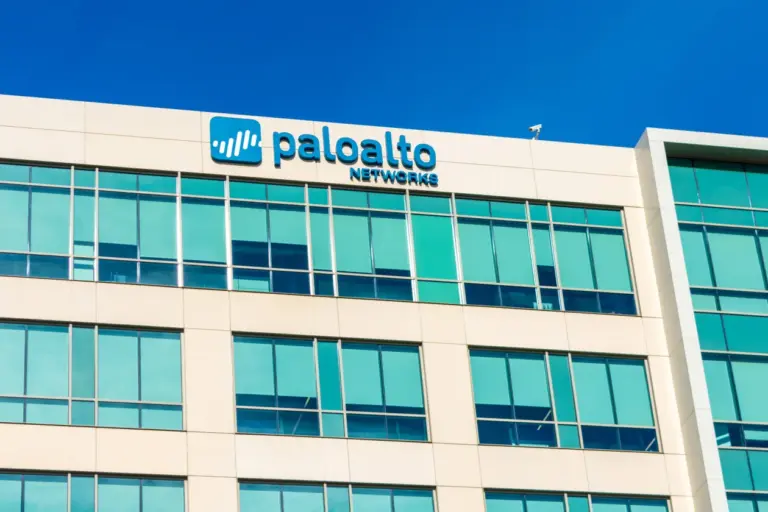Palo Alto Networks signage mounted on the exterior of a corporate office building against a clear blue sky.