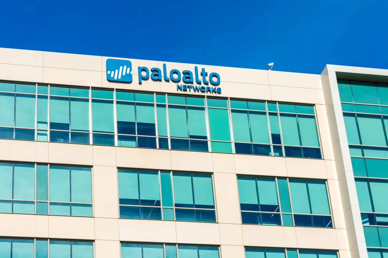 Palo Alto Networks signage mounted on the exterior of a corporate office building against a clear blue sky.