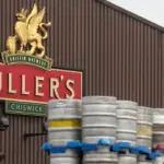 Exterior of a traditional Fuller's pub with hanging sign, on a London street.