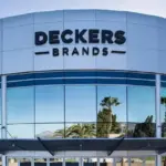 Deckers Brands sign on the curved glass and panel facade of the company's headquarters building