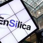 Large screen showing the EnSilica logo beside a ticker display reading EnSilica plc to AIM in a stock exchange trading hall