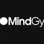 MindGym logo in white lettering with a green toggle-style graphic on a black background