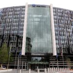 Curved glass facade of the Park Plaza Westminster Bridge hotel in London, with the Park Plaza logo above the entrance