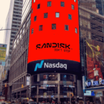 SanDisk logo displayed in black on a red LED screen above the Nasdaq sign at Times Square, New York