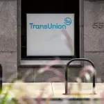 TransUnion logo sign on a granite office building entrance beside the number 555