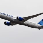 United Airlines Boeing 787 Dreamliner in flight against an overcast sky, showing the blue globe tail and UNITED livery.