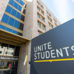 Unite Students sign outside the Morriss House entrance of a brick and glass student accommodation building
