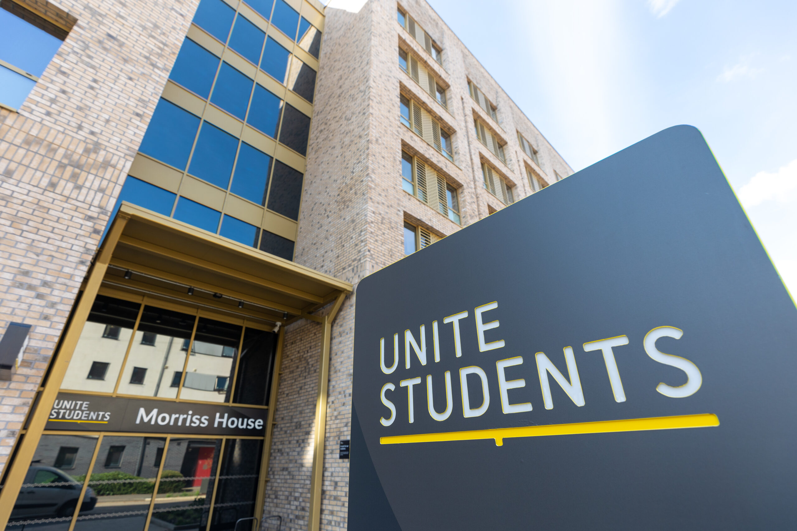 Unite Students sign outside the Morriss House entrance of a brick and glass student accommodation building