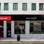Santander branch and Work Café shopfront on a UK high street, with the red Santander logo sign above the entrance