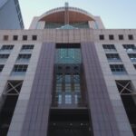 Low-angle view of the Humana headquarters building facade with the Humana name above the entrance