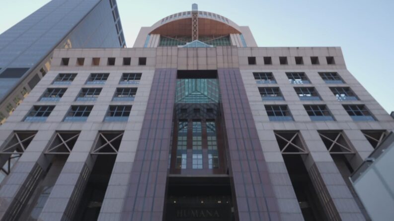 Low-angle view of the Humana headquarters building facade with the Humana name above the entrance