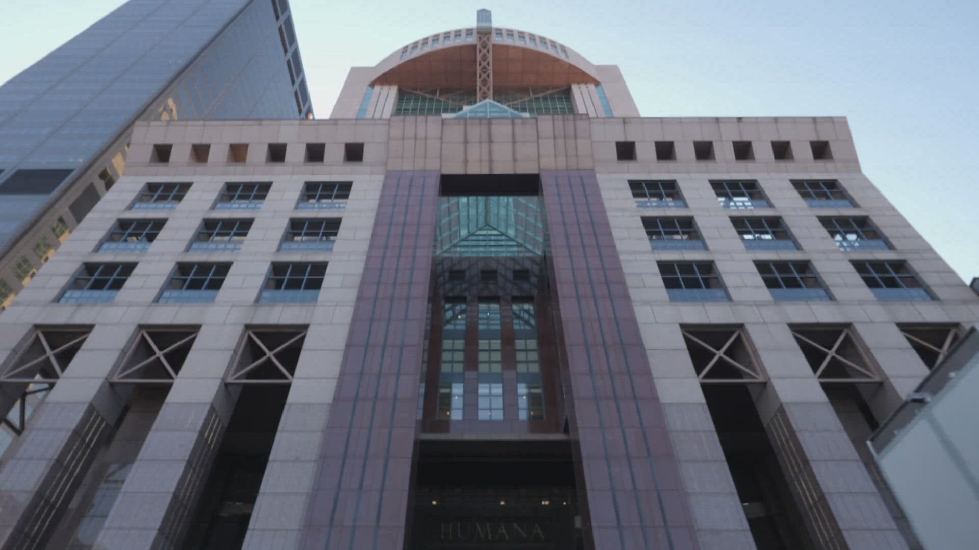 Low-angle view of the Humana headquarters building facade with the Humana name above the entrance